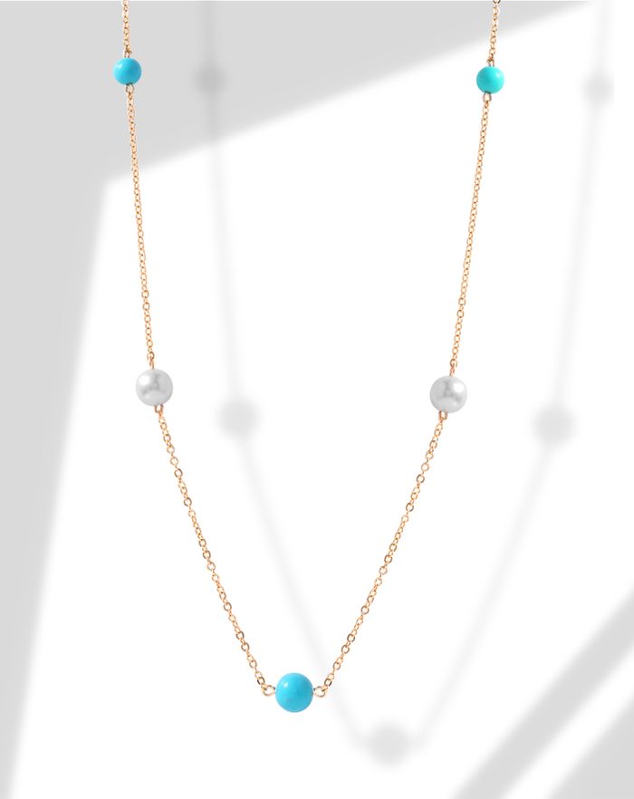 Beautiful gold necklace featuring pearls and turquoise beads, offering a touch of luxury.