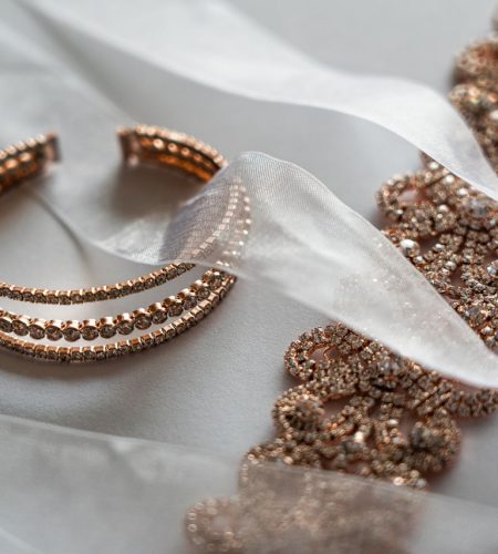 Close-up of luxurious rose gold bracelet and lace, ideal for brides.
