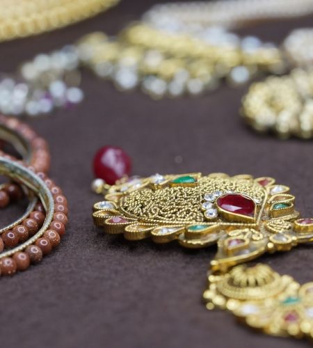 Stunning close-up of intricately designed gold and beaded jewelry showcasing traditional craftsmanship.